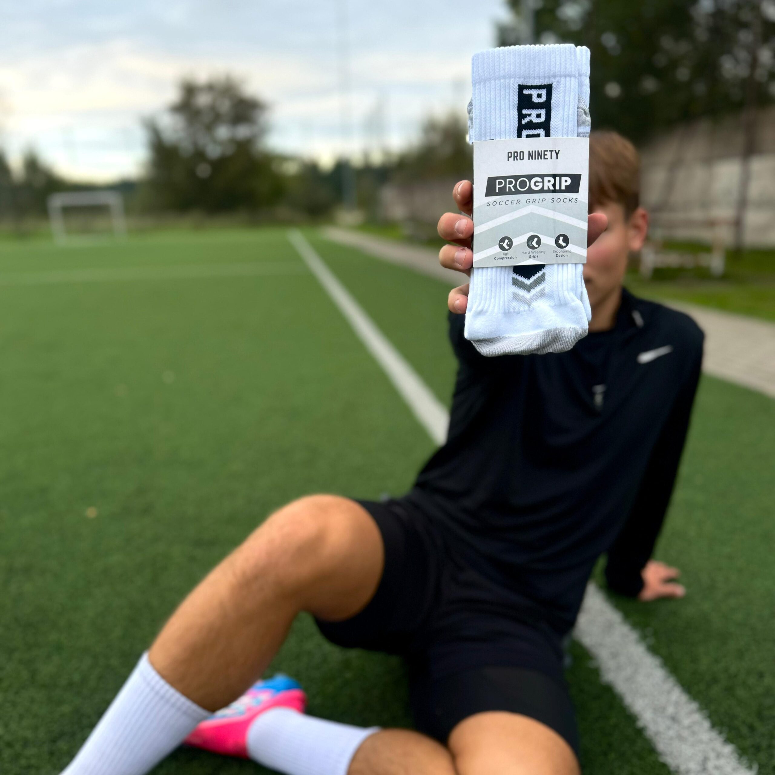 Player holding up ProGrip Football grip socks by ProNinety